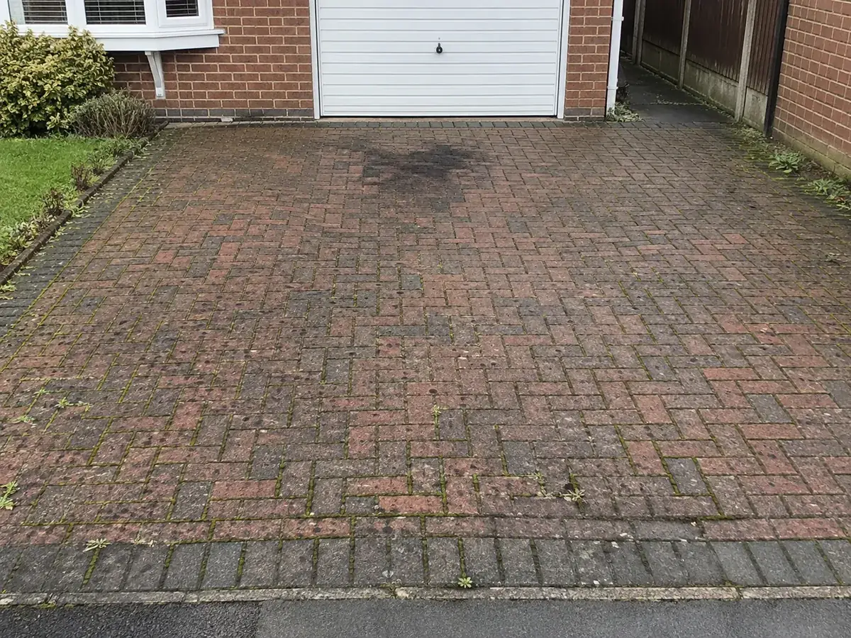 Stained block paving driveway before cleaning