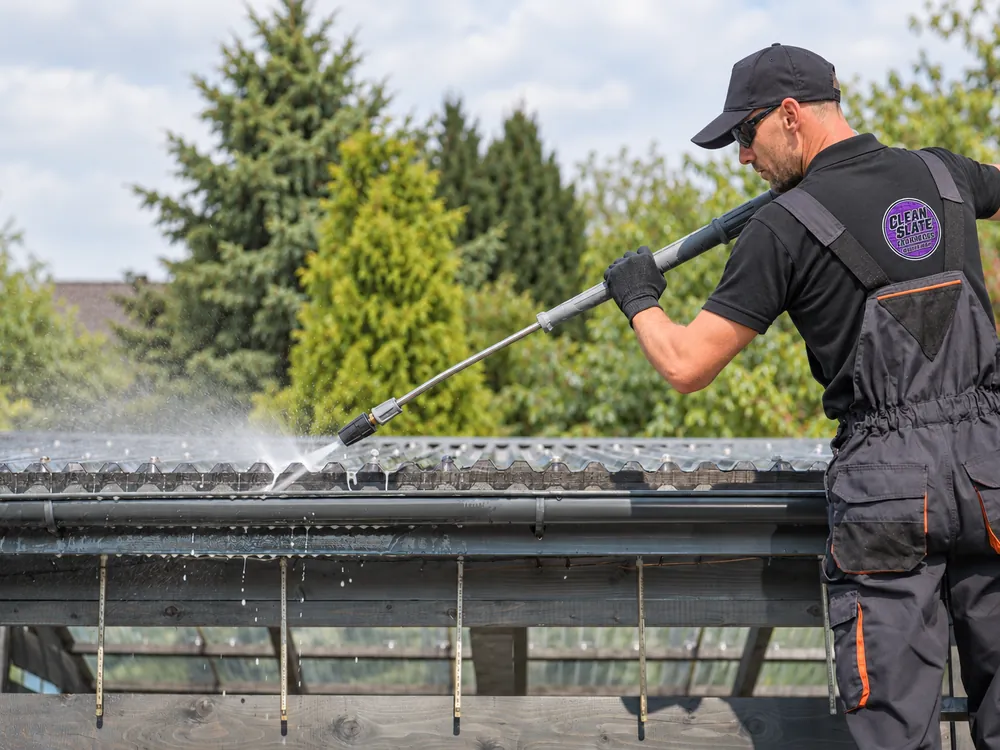 Roof and gutter being cleaned